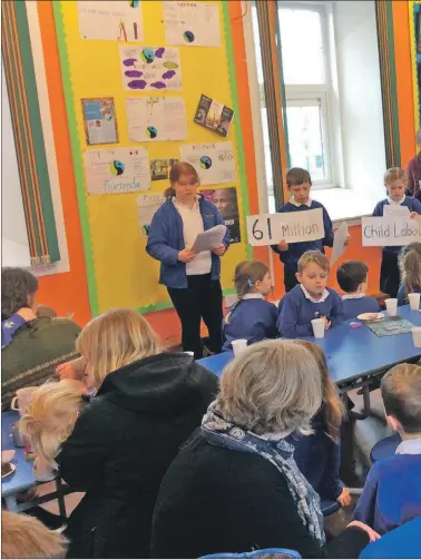  ??  ?? Shiskine pupils present their lesson on the poverty endured by farmers and children.