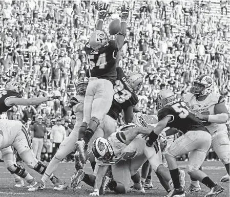  ?? Jack Dempsey, The Associated Press ?? Colorado defensive end Terrance Lang (54) blocks an extra point attempt by Oregon State to send the game into overtime Saturday at Folsom Field in Boulder. Oregon State won, 4134.