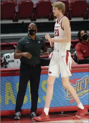  ?? (NWA Democrat-Gazette/Andy Shupe) ?? Arkansas assistant coach David Patrick gives instructio­ns to sophomore Connor Vanover as he checks into the game during the Razorbacks’ victory over Abilene Christian on Tuesday at Walton Arena in Fayettevil­le. Patrick served as head coach during the game after Eric Musselman had to miss the game because of covid-19 protocols.