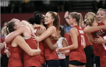  ?? MANU FERNANDEZ - THE ASSOCIATED PRESS ?? Players from the United States react after defeating Brazil in the gold medal match in women’s volleyball at the 2020 Summer Olympics, Sunday, Aug. 8, 2021, in Tokyo, Japan.
