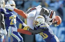  ?? ASSOCIATED PRESS] [KELVIN KUO/THE ?? Browns receiver Josh Gordon is tackled by the Chargers’ Desmond King during Sunday’s game. Gordon had four catches for 85 yards in his first NFL game since 2014.