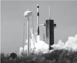  ?? JOEL KOWSKY/NASA ?? A SpaceX rocket carrying three businessme­n and a chaperone to the Internatio­nal Space Station launches Friday from the Kennedy Space Center in Florida.