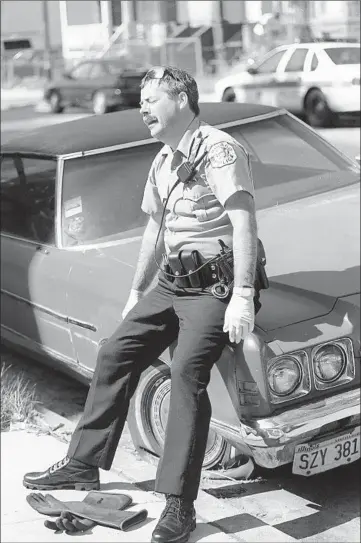  ?? PHIL GREER/CHICAGO TRIBUNE ?? Chicago police Officer Charles Henson is shaken after removing a heat victim’s body from an apartment July 17, 1995.