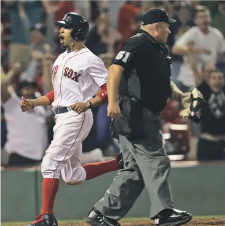  ?? STAFF PHOTO BY JOHN WILCOX ?? FINALLY! Mookie Betts is pumped as he crosses the plate with the winning run in the 19th inning last night for a 3-2 win over the Blue Jays at Fenway Park.