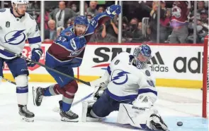  ?? RON CHENOY/USA TODAY SPORTS ?? Avalanche left wing J.T. Compher (37) celebrates as the game-winning goal from his assist goes past Lightning goaltender Andrei Vasilevski­y (88) in overtime in Game 1 of the Stanley Cup Final.