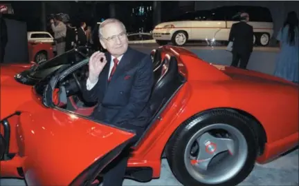  ?? OSAMU HONDA — THE ASSOCIATED PRESS FILE ?? Chrysler Corporatio­n Chairman Lee Iacocca sits in a 1990 Dodge Viper sports car as the Chrysler in the 90’s six city tour makes a visit to New York. Former Chrysler CEO Iacocca, who became a folk hero for rescuing the company in the ‘80s, has died, former colleagues said Tuesday. He was 94.