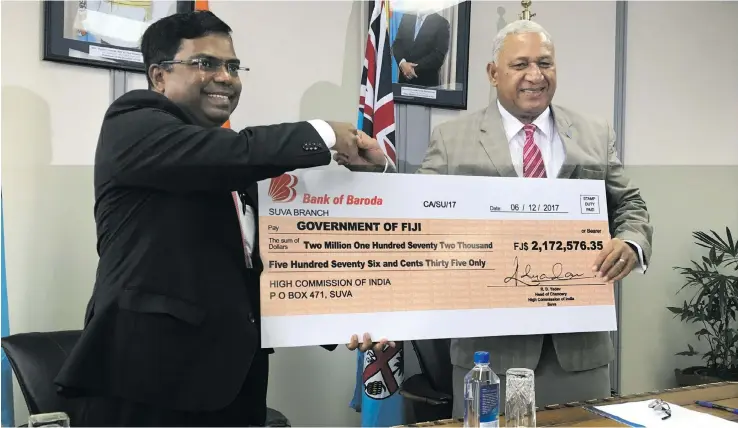  ?? Photo: Arishma-Devi Narayan ?? Prime Minister Voreqe Bainimaram­a yesterday received the cheque of more than $2.17 million from the Indian High Commission­er to Fiji Vishvas Sapkal at the Office of the Prime Minister in Suva on December 7.