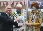  ?? ?? Councillor Roland Emmas Williams presents the Ripley Morris history to Ashley Copeland as Alex Bowness looks on