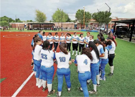  ?? [PHOTOS BY DOUG HOKE, THE OKLAHOMAN] ?? Southeast softball players gather before a game on their new field.