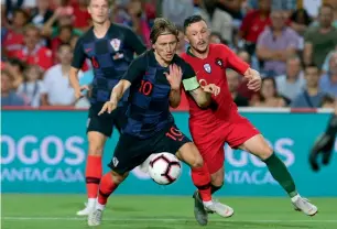  ?? AP ?? Croatia’s Luka Modric fights for the ball with Portugal’s Mario Rui. —