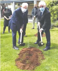  ?? (Mark Nayman/GPO) ?? PRESIDENT REUVEN RIVLIN and Prof. Eli Feinerman, head of the Volcani Institute, plant olive saplings in the grounds of the President’s Residence to mark the 100th anniversar­y of the Volcani Institute.