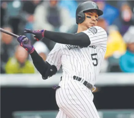  ?? David Zalubowski, The Associated Press ?? After battling a slump most of this season, Rockies outfielder Carlos Gonzalez is hitting .371 this month with 11 doubles, five homers and 15 RBIs. He is close to wrapping up a seven-year contract worth $80 million.