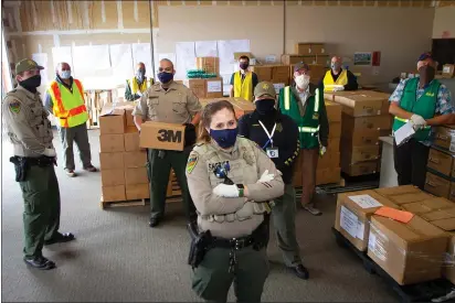  ?? PHOTO PROVIDED BY HUMBOLDT COUNTY JOINT INFORMATIO­N CENTER ?? McKinleyvi­lle and Humboldt Bay Fire Community Emergency Response Team volunteers met on Friday with EOC Logistics staff and Humboldt County Sheriff’s Office deputies to load up more than 10,000PPE units that were delivered to 42local first responder agencies. From left, Deputy Michael Osser, Jose Gonzalez, Sarah Self, Deputy Effrain Sanchez, Deputy Jennifer Hudson, Calvin Copeland, Deputy Ana Hernandez, CERT member Donald Campbell, CHP Officer Paul Craft and CERT member Cliff Van Cott.