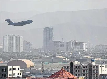  ?? AFP VIA GETTY IMAGES ?? A U.S. aircraft takes off from the military airport in Kabul on Friday. The U.S. continued its airlift in the Afghan capital the day after a suicide attack. President Joe Biden has set a Tuesday deadline to end the airlift.