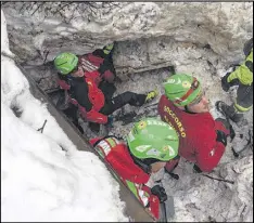  ?? THE NATIONAL ALPINE CLIFF AND CAVE RESCUE CORPS (CNSAS) VIA AP ?? Rescue workers work in the area of the Hotel Rigopiano, central Italy, on Saturday. The hotel was buried under tons of snow Wednesday in an avalanche.