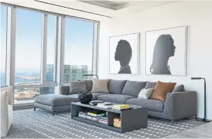 ?? TIM COY PHOTOS ?? Silhouette­s of Black women by American artist Erica Deeman make a striking focal point in the living room of the condo that overlooks San Francisco Bay.
