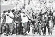  ?? Kevin C. Cox Getty Images ?? NGOZI OKOBI is raised aloft as the Nigerian team celebrates its tie against heavily favored Sweden.