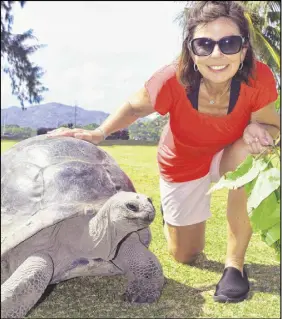  ?? STEVE MACNAULL PHOTO ?? Tyson the 120-year-old tortoise hangs out with Kerry Macnaull on Curieuse island in the Seychelles.