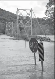  ?? File photo/NWA Democrat-Gazette/BEN GOFF • @NWABENGOFF ?? The deck of Beaver Bridge floats in the flooded White River April 30 in the Beaver community.