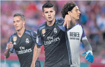  ??  ?? Alvaro Morata, centre, celebrates scoring a goal for Real Madrid.