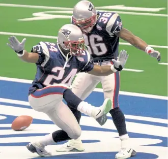  ?? Tony Gutierrez, The Associated Press ?? New England Patriots cornerback Ty Law (24) celebrates with teammate Lawyer Milloy after Law’s intercepti­on of a pass by St. Louis Rams’ Kurt Warner for a touchdown during the second quarter of Super Bowl 36 in 2002. Law is one of three teammates of Tom Brady already in the Pro Football Hall of Fame.