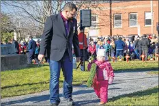  ?? COLIN CHISHOLM ?? People of all ages helped out at the ceremony, laying wreaths and poppies.