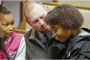  ?? Tribune News Service ?? Joey Gilbert, center, talks to Alasjah Haynes, 7, of Waveland, and her sister, Jada, 12, before services at Bayside Baptist Church in Waveland, Miss.