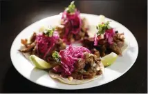  ??  ?? North’s Vietnamese tacos are piled with barbecue pork, pickled red cabbage, cilantro and Sriracha aioli.