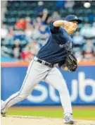  ?? THE ASSOCIATED PRESS ?? The Atlanta Braves’ Michael Soroka delivers a pitch during the first inning against the New York Mets on Tuesday in New York. The Braves held on for a 3-2 victory, giving Soroka his first big-league victory.