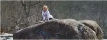  ?? NANCY ROBERTS ?? Sophie Gunther, president of the Rockheads junior group of the North Mississipp­i Gem & Mineral Society, sits a top one of the various humongous pink granite rocks at Elephant Rocks State Park, located in southeaste­rn Missouri.