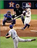  ??  ?? HOUSTON ASTROS’ JOSE ALTUVE hits a three-run home run off Los Angeles Dodgers pitcher Kenta Maeda during the fifth inning of Game 5 of the World Series on Sunday in Houston.
