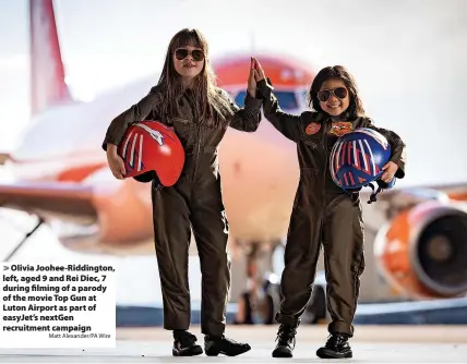  ?? Matt Alexander/PA Wire ?? Olivia Joohee-Riddington, left, aged 9 and Rei Diec, 7 during filming of a parody of the movie Top Gun at Luton Airport as part of easyJet’s nextGen recruitmen­t campaign