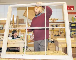  ?? JIM DAY/THE GUARDIAN ?? Octavio Salcedo of an architectu­ral firm in Montreal that specialize­s in conservati­on, gave Holland College heritage retrofit carpentry students a workshop Wednesday to prepare them to work on the restoratio­n of two large windows from Province House. Carpentry student Sebastian Saez listens to Salcedo's instructio­ns.