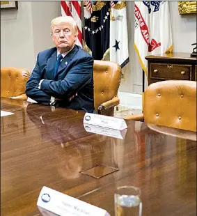  ?? The New York Times/DOUG MILLS ?? President Donald Trump sits in a White House meeting Tuesday beside empty seats that had been reserved for House Minority Leader Nancy Pelosi and Senate Minority Leader Charles Schumer.