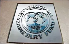  ?? BRENDAN SMIALOWSKI/AFP ?? This file photo taken on June 30, 2015, shows the IMF logo seen outside its headquarte­rs in Washington, DC.