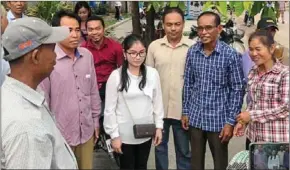  ?? SUPPLIED ?? Six former CNRP officials wait outside Battambang provincial court on May 9.