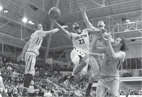  ?? FRANK GUNN/THE CANADIAN PRESS ?? Carleton’s Philip Scrubb drives to the hoop, splitting the Victoria defence in Saturday’s semifinal at the CIS championsh­ip at Mattamy Athletic Centre.