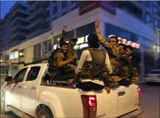  ?? EMRAH GUREL — THE ASSOCIATED PRESS FILE ?? Turkish-backed Syrian opposition fighters from the Syrian National Army, flash the V-sign as they are driven through the town of Akcakale, Sanliurfa province, southeaste­rn Turkey, on their way to enter over the border to Tel Abyad, Syria.