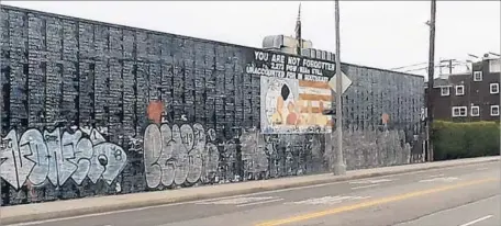  ?? Photograph­s by Stewart Oscars ?? VANDALS scrawled graffiti over a mural in Venice that bears the names of 2,273 soldiers counted as either prisoners of war or missing in action in Vietnam. “It’s like a direct attack,” said longtime resident Stewart Oscars. “If you have any sense of...