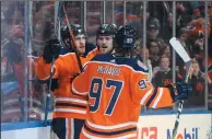  ?? THE CANADIAN PRESS/JASON FRANSON ?? Edmonton Oilers' Leon Draisaitl (29), Oscar Klefbom (77) and Connor McDavid (97) celebrate an overtime goal against the Dallas Stars in Edmonton Tuesday.