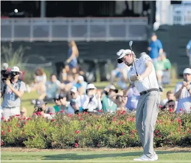  ?? LYNNE SLADKY/AP ?? Webb Simpson drives from the drop zone after hitting into the water on the 17th hole during Friday’s round at the TPC.