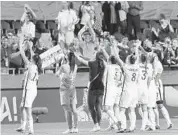  ?? NICHOLAS KAMM/AFP/GETTY IMAGES ?? United States players celebrate after their win Friday over China in the quarterfin­als.