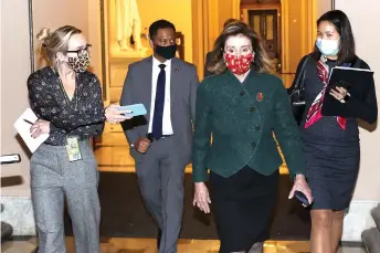  ?? — AFP photo ?? Pelosi heads back to her office a er leaving the house floor in Washington, DC.