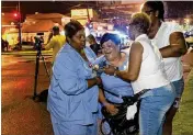  ?? ADVOCATE VIA AP MATTHEW HINTON / THE ?? People react at the scene of a shooting in New Orleans on Saturday night. Police responding to the scene found three victims — two men and one woman — who were pronounced dead at the scene.