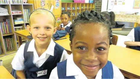  ??  ?? GOOD TEAM: On their first day at school these two Balmoral grade 1s knew exactly what they want to be when they were big. Anine Prinsloo, left, wants to be a doctor and Nonceba Mkanda a nurse Picture: CHUX FOURIE