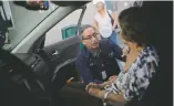  ?? RAMON ESPINOSA/THE ASSOCIATED PRESS ?? Dr. Victor Rivera attends to Carmen Hernandez in a car in the hospital’s parking lot for lack of space at the hospital Thursday in Bayamon, Puerto Rico.