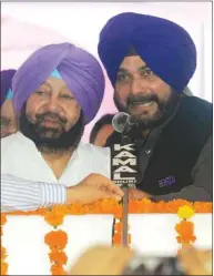  ??  ?? Punjab Chief Minister Amarinder Singh and Local Government Minister Navjot Singh Sidhu press a remote button during the inaugurati­on ceremony to lay the foundation stone of five projects in Amritsar yesterday.