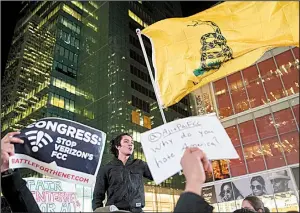  ?? AP/MARY ALTAFFER ?? Supporters of Net neutrality hold a rally in New York City as protests sprang up Thursday outside Verizon stores across the country.