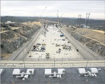  ?? THE ASSOCIATED PRESS ?? Crews work to repair the damaged main spillway of the Oroville Dam in October 2017.