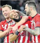  ??  ?? SMILES: Redmond with Ings (right) and Ward-Prowse (left) after Saints’ second